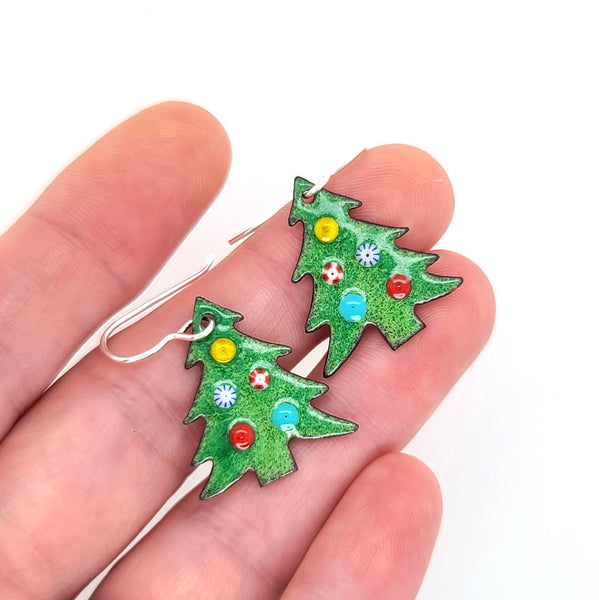 green Christmas tree earrings in hand