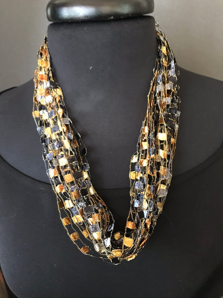 bronze and black necklace made of ribbon