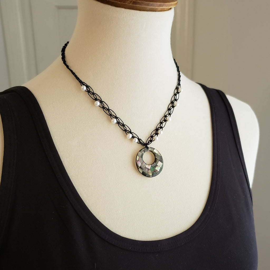 mother of pearl inlay necklace on black linen